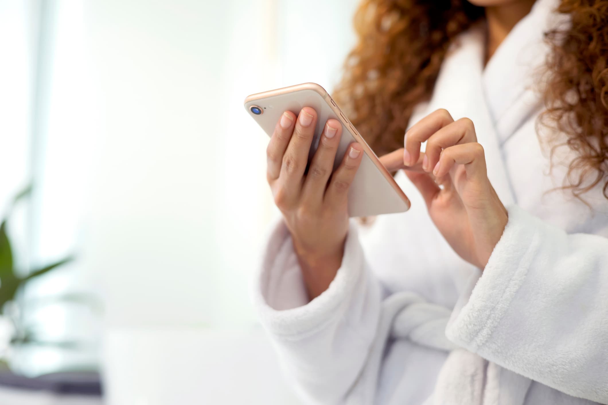 woman scrolling phone in bathroom