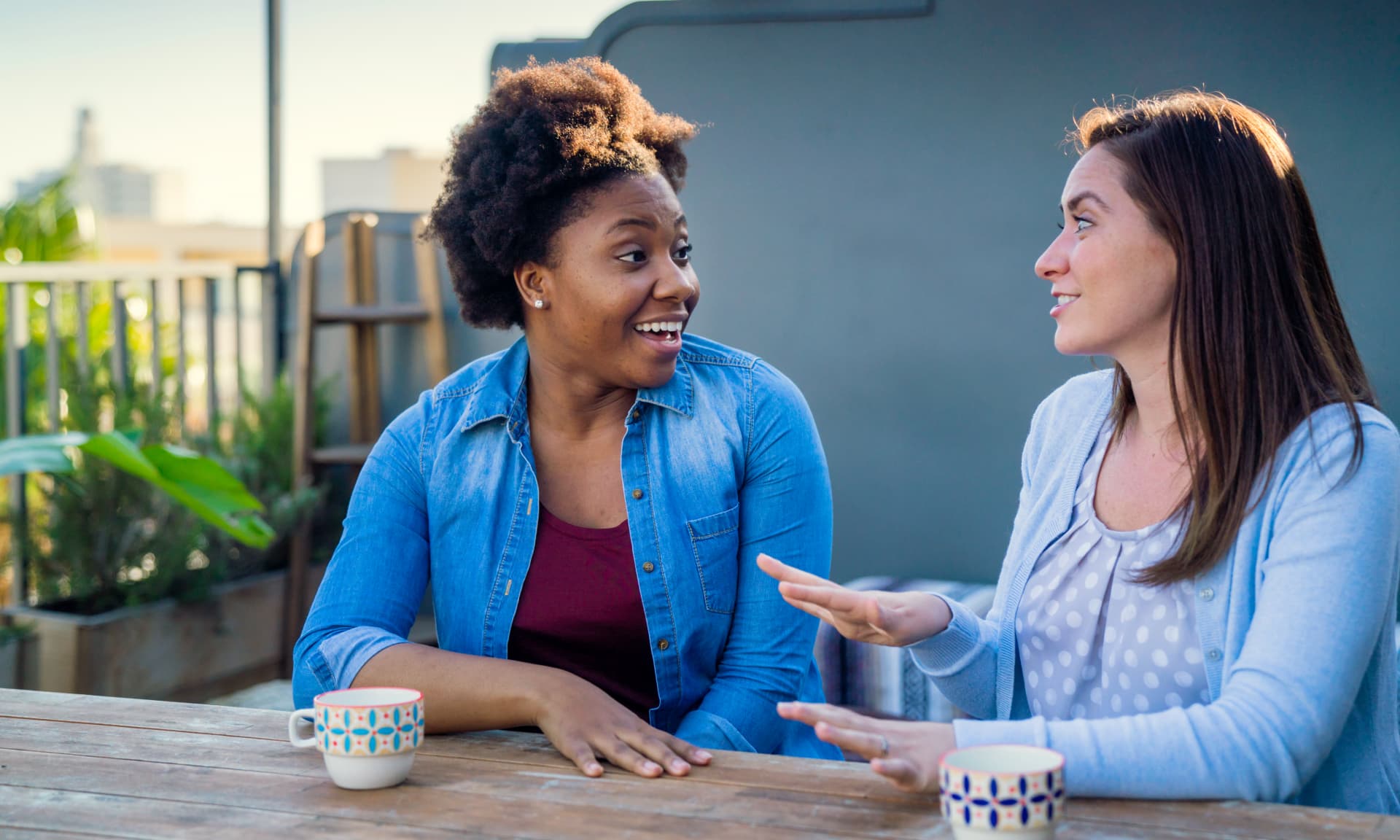 Two women talking while drinking coffee