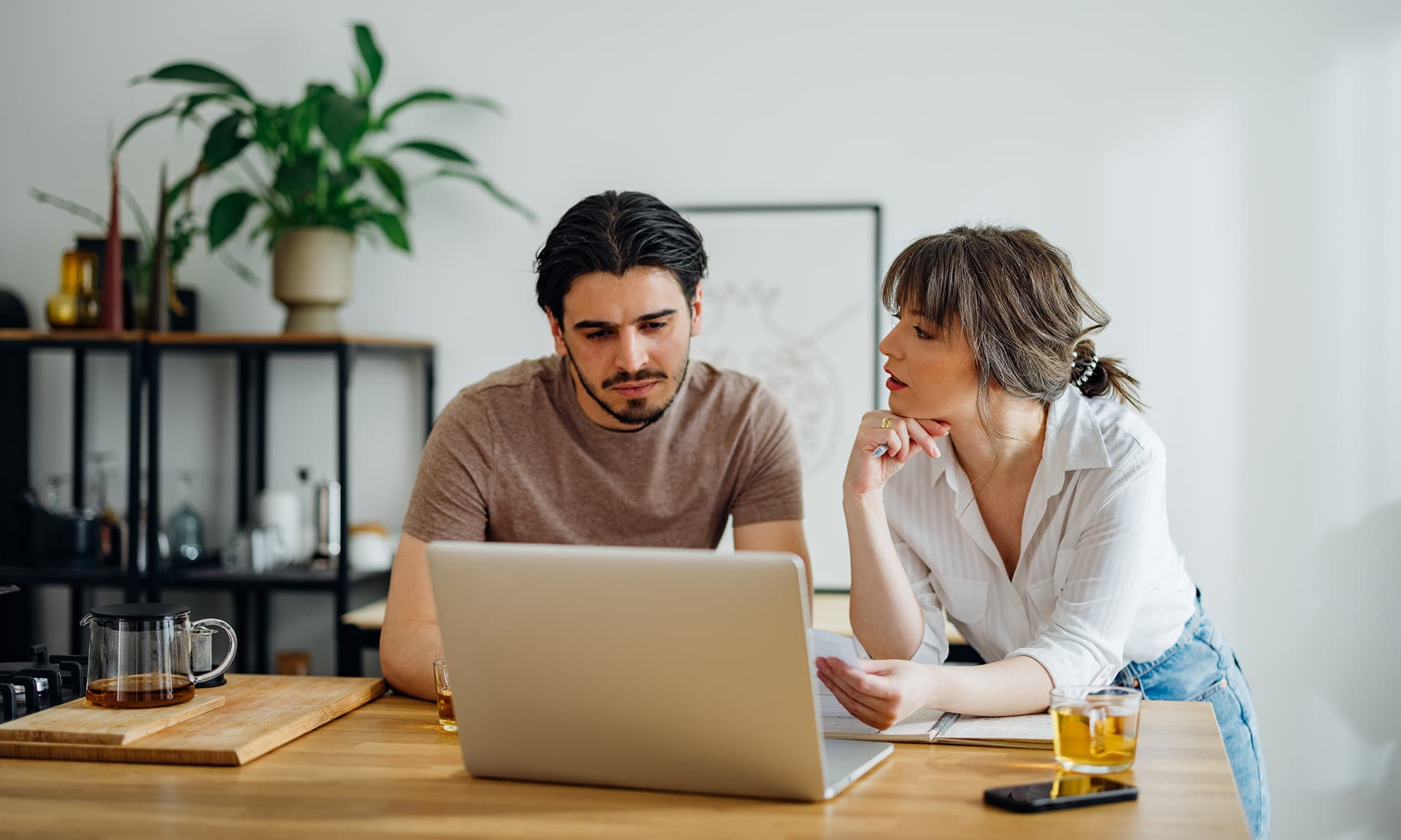 A couple discussing finances at a computer