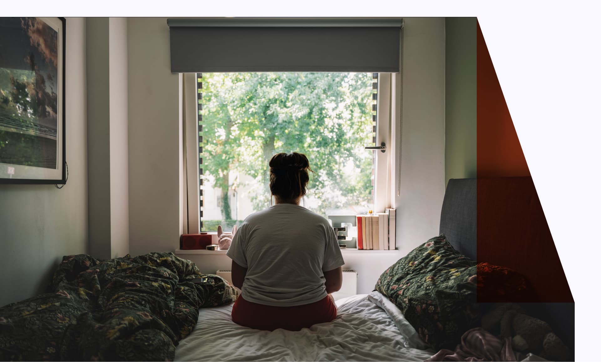 A person sitting on their bed