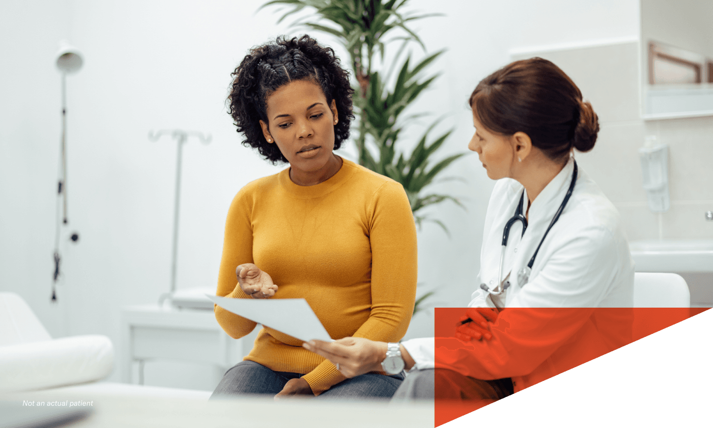 A woman discussing a document with her doctor